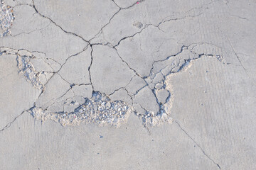 Cracks and broken texture of damaged concrete floor