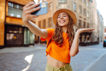 Selfie time. A tourist walks the streets and  takes selfie using smartphone camera.   Lifestyle, travel, tourism, active life.
