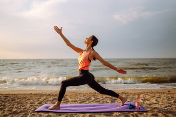 A sporty woman does exercises in the open air. Healthy lifestyle, sports activities in the morning in the beach.