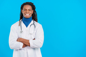 Latin male doctor with dreadlocks smiling with arms crossed