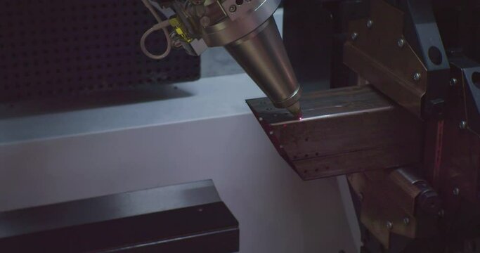 industrial equipment.metalworking.high precision cnc machine makes a complex metal part using a laser. close-up.