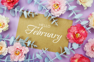 Hello February typography text and flower decorate on purple background