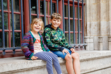 Two happy siblings, little girl and school boy together. Smiling brother and sister, best friends. Family in love.