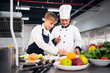 Chef teaching students to cook in the kitchen at a cooking school