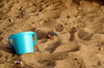 Fototapeta na wymiar Old toys in the sandbox