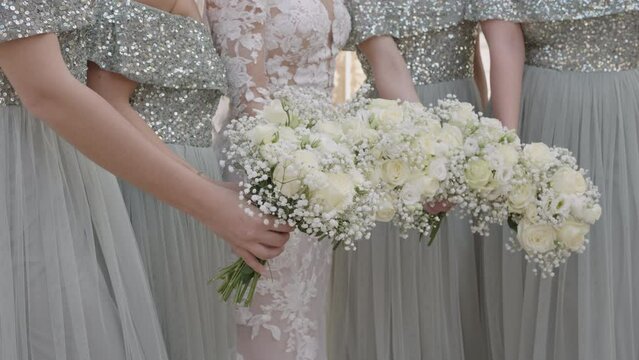 Bride and bridesmaids with the bouquet, close up