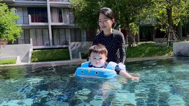 Child and mom is swimming at moning
