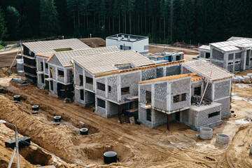 Construction site of residential area with ecological and sustainable green residential buildings,...