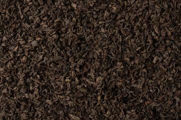 Dried tea leaves as a background.