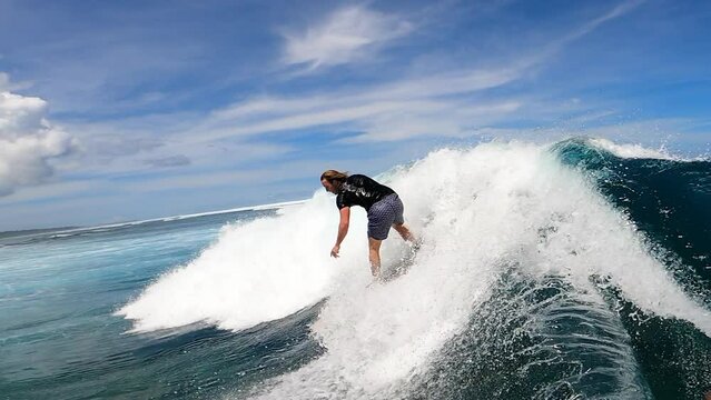 Surfer Having Fun Riding A Giant Ocean Wave