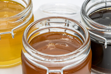 Closeup of Jars with three different types of honey
