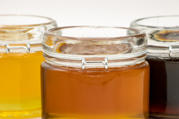 Closeup of Jars with three different types of honey