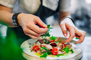Chef cooking Beef tongue salad with fresh vegetables on restaurant kitchen