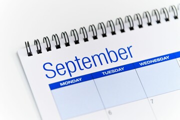 Closeup of a calendar opened on the September month page and placed on a white background