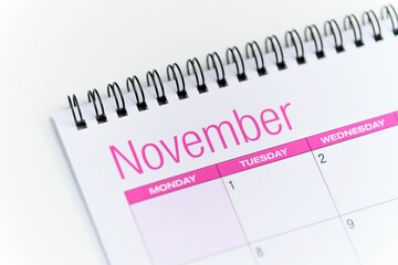 Obraz premium Closeup of a calendar opened on the November month page and placed on a white background