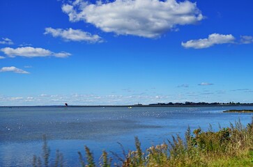 Image of a water surface with a beautiful blue sky with clouds