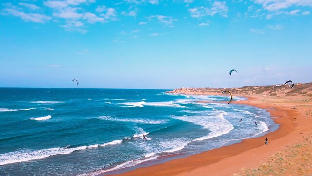 A group of people kite surfing at Alagadi Beach in Kyrenia, North Cyprus on sunny day with clear sky