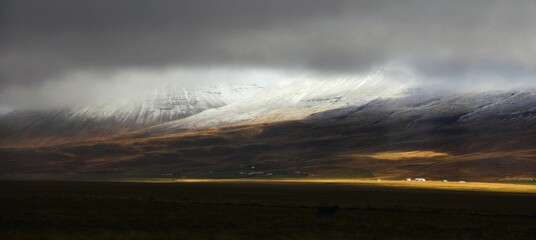 Beautiful scenery of an epic landscape with mountain and stormy sky in Iceland during autumn