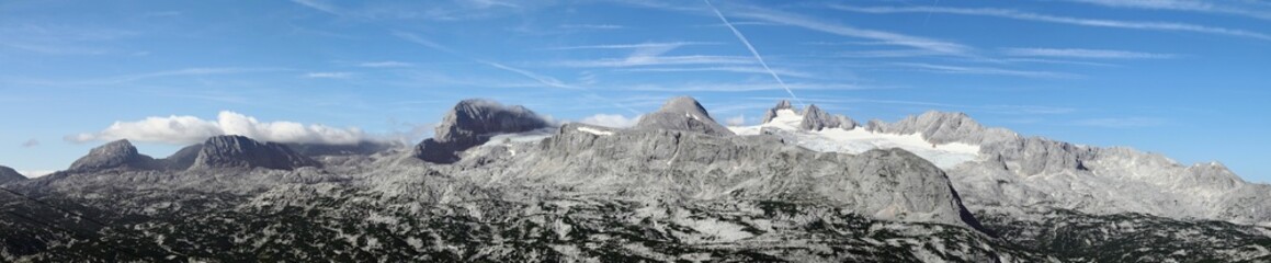 Panoramic view of the mighty Dachstein Glacier covered in snow in the Austrian Alps under blue sky