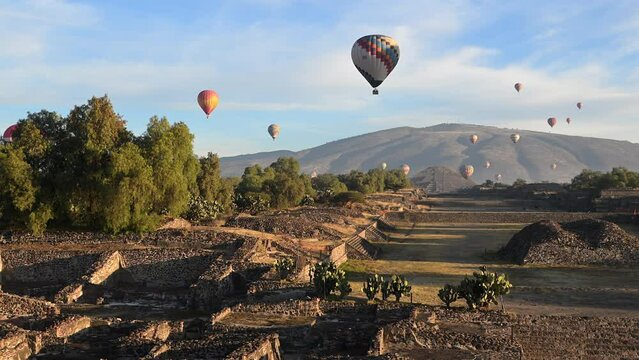 Hot air balloons soar over the ancient Pyramids of the Moon and Sun in Teotihuacan, Mexico.⁣ The ceremonial site holds thousands of homes and temples that are comparable to the pyramids of Egypt.