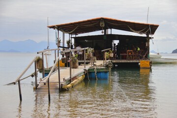 Fototapeta na wymiar Pontoon boat on the surface of water at Ilha Grande island, Brazil