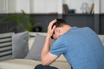 Headache and migraine, man with head pain at home