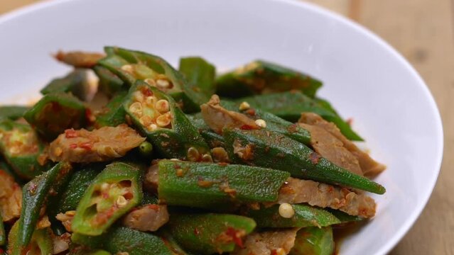 Close up shot of cutted okra meal, Organic Homemade stir fly green okra with curry and meat. Healthy food for diet.