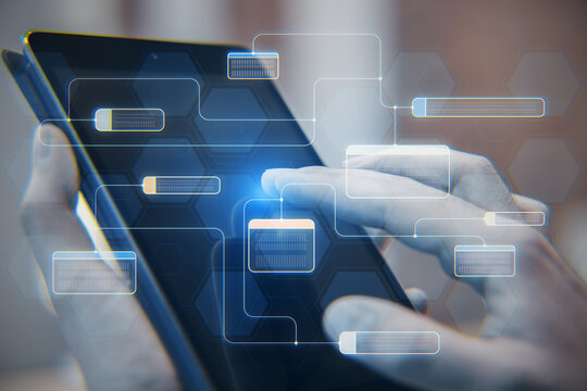 Software system technologies and research concept with digital connected node buttons on blurry background. Close up of male hand using tablet with mesh. Double exposure.