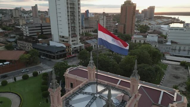 Paraguay flag waving at wind above  Palacio de L&oacute;pez in the capital city of Asuncion, Paraguay, South America. Drone locked shot