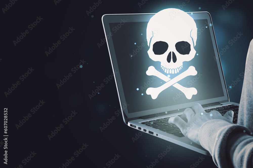 Poster Close up of hand using laptop with glowing white skull hologram on dark background with mock up place for your text. Cyber attack and malware concept.