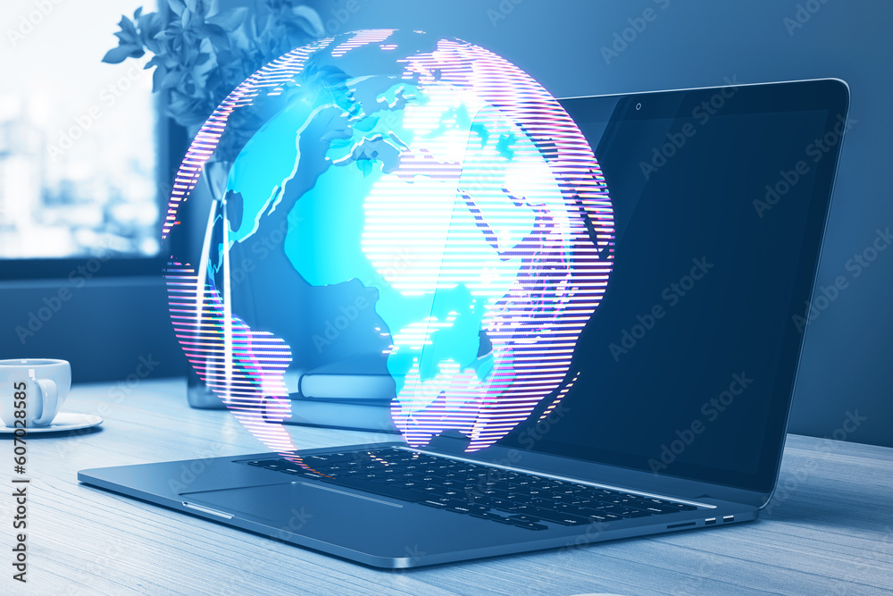 Poster close up of workplace with laptop and glowing digital globe hologram on blurry background. digital w