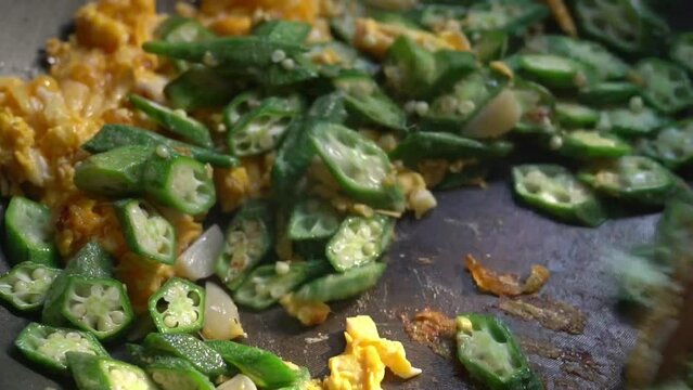 Organic Homemade stir fly green okra with eggs and pickled garlic. Healthy food for diet.