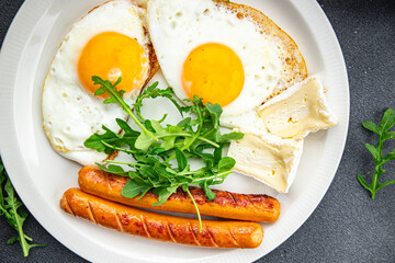 fried egg with sausages breakfast green leaves lettuce arugula healthy meal food snack on the table copy space food background rustic top view