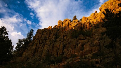 Red rock formations against a blue clouded sky