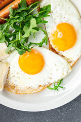 fried egg with sausages breakfast green leaves lettuce arugula healthy meal food snack on the table copy space food background rustic top view