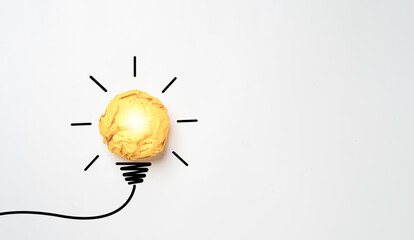 Yellow scrap paper ball with illustration painting for virtual lightbulb. It is creative thinking idea for problem solving and innovation concept.