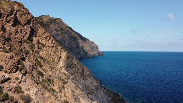 Calblanque coast aerial drone view point of coastline of mountains against mediterranean seascape in Cartagena coasts, Spain.