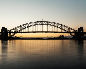 Fototapeta na wymiar Silhouette of a bridge near the Sydney Opera House at sunset