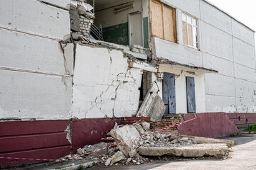 Destroyed residential building wall after russian missle rocket attack during war in Ukraine. Ruins...
