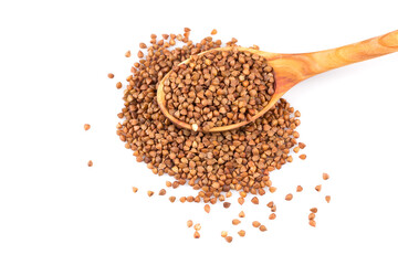 Uncooked buckwheat on wooden spoon
