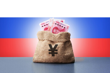 Bag money with chinese yuan banknotes and Russia flag. Concept of economic cooperation between the...