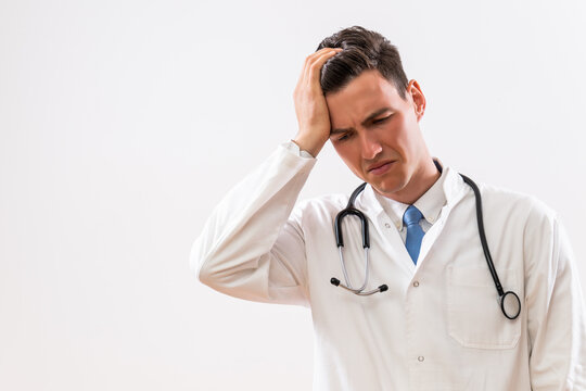 Image of worried and tired doctor thinking.	
