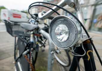 Fototapeta na wymiar Bicycle with bike lamp parking in city