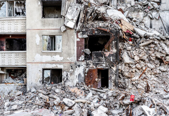 Destroyed residential building wall after russian missle rocket attack during war in Ukraine. House ruins in Kharkiv after terrorist agression