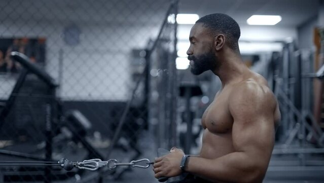 Athletic African American man doing Seated cable rows side angle