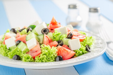 Delicious and homemade Greek salad with olives, feta and lettuce.