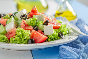 Delicious and homemade Greek salad with tomatoes, cheese and lettuce.