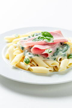 Tasty and homemade pasta with spinach and bechamel sauce.