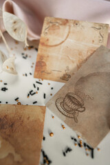 Textured paper cards with coffee drops and a picture of a coffee cup on a pink silk fabric background.