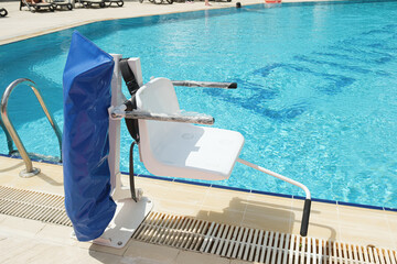 Disabled person pool lift. Swinging arm disabled chair. Swimming pool lift with a chair. Solution...